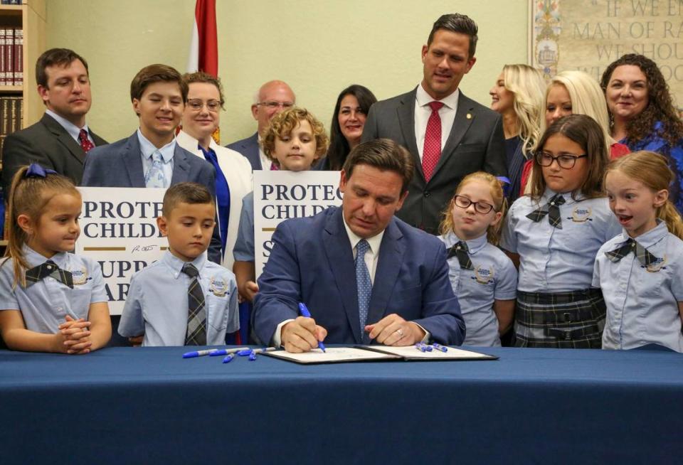 Florida Gov. Ron DeSantis signs the Parental Rights in Education bill at Classical Preparatory school Monday, March 28, 2022, in Shady Hills, Fla.