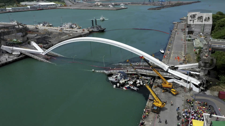 This image made from video provided by Taiwan's Military News Agency shows Nanfangao Bridge, collapsed in Nanfangao, eastern Taiwan, Tuesday, Oct. 1, 2019. The towering arch bridge over a bay collapsed Tuesday, sending a burning oil tanker truck falling onto boats in the water below. (Taiwan's Military News Agency via AP)