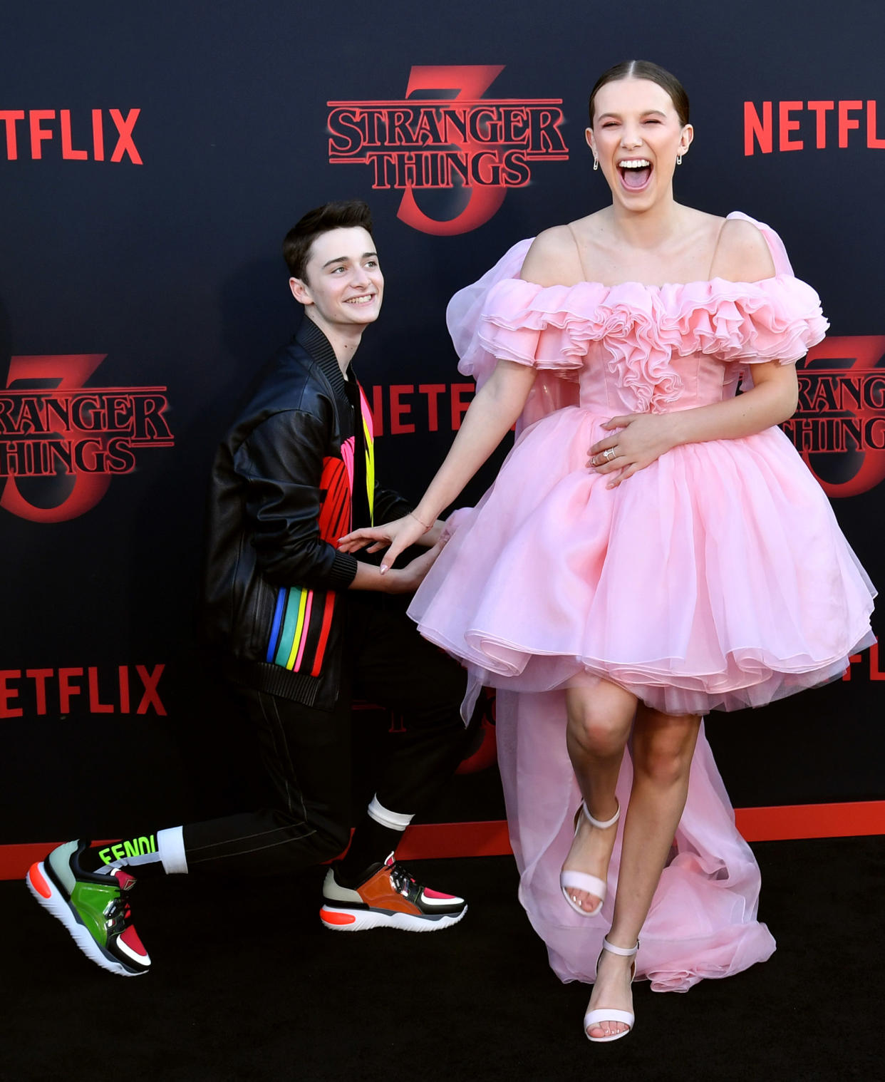 Noah Schnapp (L) and Millie Bobby Brown attend the premiere of Netflix's 