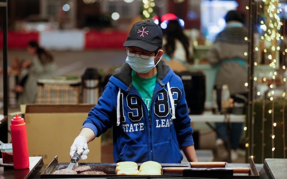  A vendor prepares hamburgers at a food stall at Al Aali Mall amid the pandemic in Bahrain - Reuters