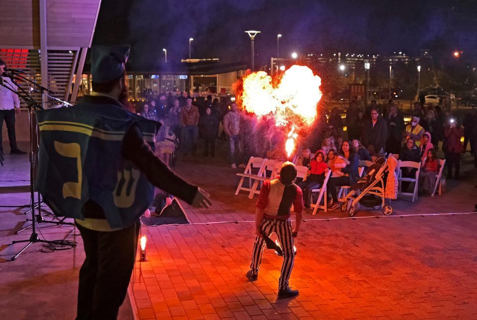 Fire performer Bryan Sekine entertains the crowd during "Scissortail Lights," a community Hanukkah celebration on Sunday at Scissortail Park in downtown Oklahoma City.