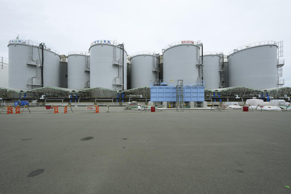 A black pipeline runs along tanks containing treated radioactive wastewater at the Fukushima Daiichi nuclear power plant in Futaba town, northeastern Japan, Friday, July 14, 2023. Tomohiko Mayuzumi, a spokesperson of Tokyo Electric Power Company Holdings, says treated radioactive water carried through the black pipeline will be diluted with more than hundred times the seawater in the blue pipe to levels much safer than international standards, before released into the sea. (AP Photo/Hiro Komae)