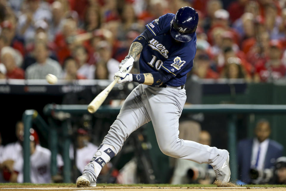 FILE - In this Oct. 1, 2019, file photo, Milwaukee Brewers Yasmani Grandal (10) hits a two-run home run during the first inning of a National League wild card baseball game against the Washington Nationals, at Nationals Park in Washington. All-Star catcher Yasmani Grandal agreed to a $73 million, four-year contract with the Chicago White Sox, finding a more lucrative free-agent market now that he no longer is burdened by draft-pick compensation. Grandal will earn $18.25 million annually as part of the deal announced Thursday, Nov. 21, 2019. (AP Photo/Andrew Harnik, File)