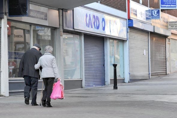 File photo dated 13/12/11 of people walking past closed shops as a project has been launched to encourage young people to consider opening a high street business to help revitalise 