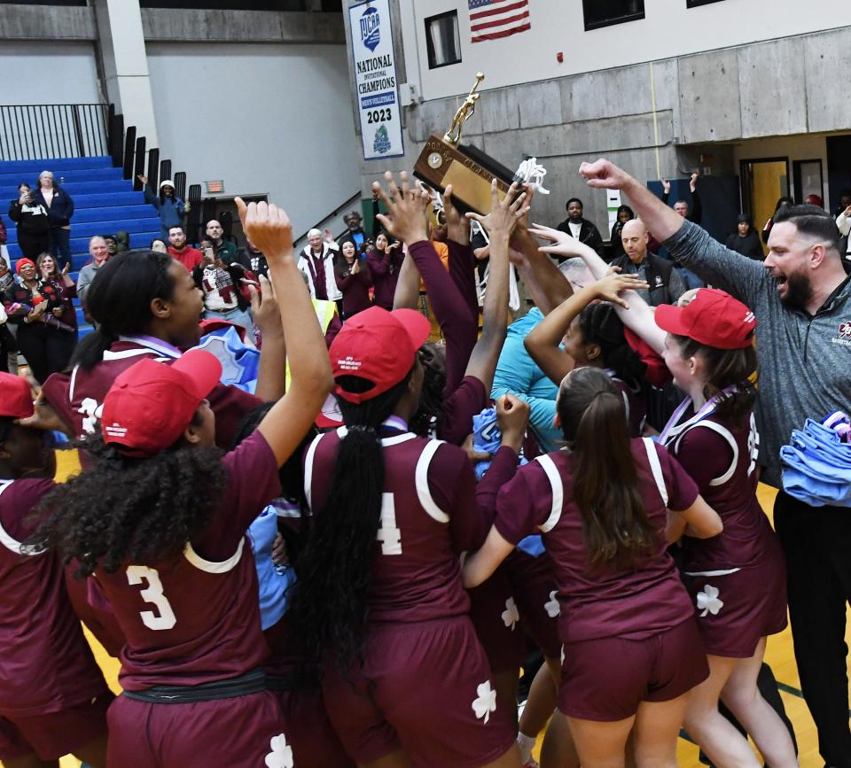 Aquinas celebrates with the Section V Class A trophy after pulling out the win against Pittsford Sutherland.