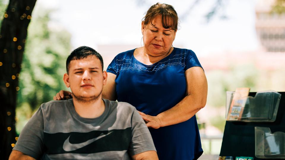 Nora Perez stands behind her son Angel Mendivil Perez just outside their attorney&rsquo;s offices in downtown Tucson, Arizona, on Aug.12, 2019. (Photo: Ash Ponders for HuffPost)