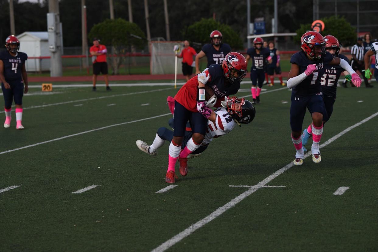 All Saints running back Trey Bell powers over Master's Academy in an eventual 40-0 victory.