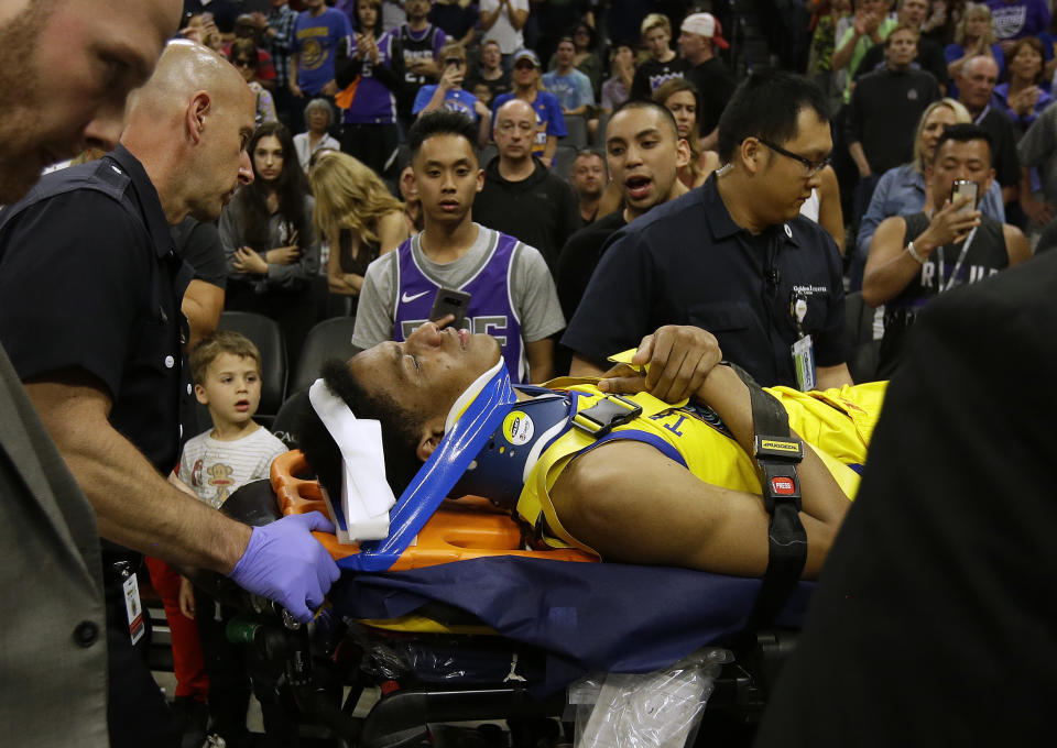 Golden State Warriors guard Patrick McCaw is taken off the court on a stretcher after falling hard to the floor late in the third quarter following a Flagrant 1 foul by Sacramento Kings’s Vince Carter in an NBA basketball game Saturday, March 31, 2018, in Sacramento, Calif. The Warriors won 112-96. (AP Photo/Rich Pedroncelli)