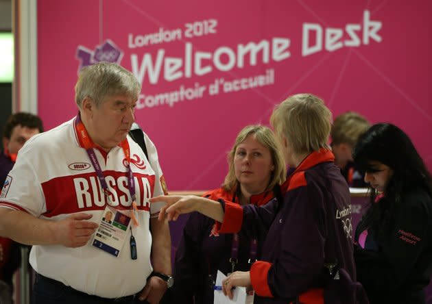 LONDON, ENGLAND - JULY 16: A Russian Olympic team official is given assistance at Heathrow Airport on July 16, 2012 in London, England. Athletes, coaches and Olympic officials are beginning to arrive in London ahead of the Olympics. (Photo by Peter Macdiarmid/Getty Images)