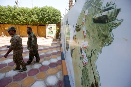 Members of Iraqi Popular Mobilisation Forces (PMF) are seen at the headquarters of the seventh brigade in Basra