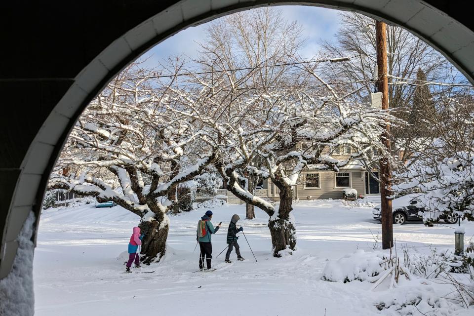 People make their way through a snow-covered street in the Grant Park neighborhood of Portland, Ore., Feb. 23, 2023. A winter weather advisory has been issued for the Portland area on Tuesday, Feb. 28, with more snow expected.