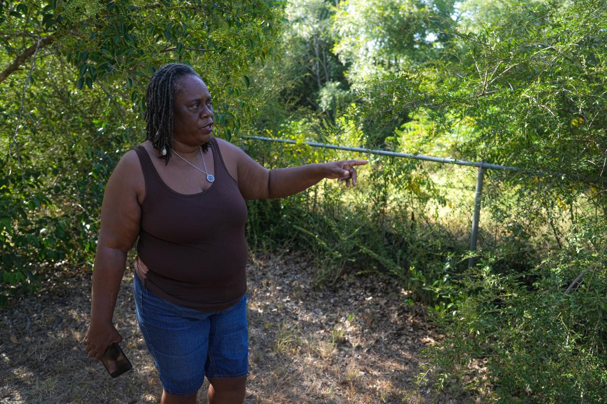 Sue Spears, president of the Bethany Cemetery Association, shows where a 592-unit apartment complex is planned next to the historic Black cemetery in East Austin.