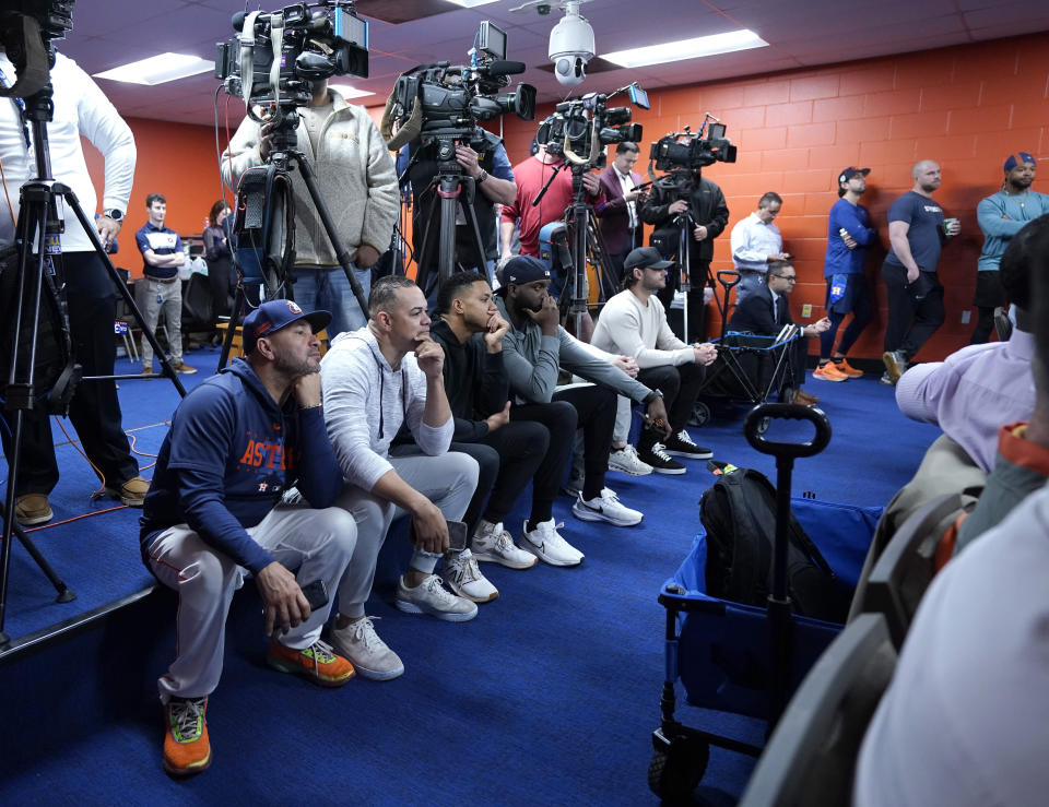 Houston Astros players and staff sit in the back of the interview room during a press conference announcing the agreement to a five-year contract extension for Jose Altuve at Minute Maid Park on Wednesday, Feb. 7, 2024, in Houston. Altuve and the Houston Astros have agreed to a $125 million, five-year contract that covers 2025-29. Houston announced the new multiyear deal for Altuve on Tuesday. (Karen Warren/Houston Chronicle via AP)
