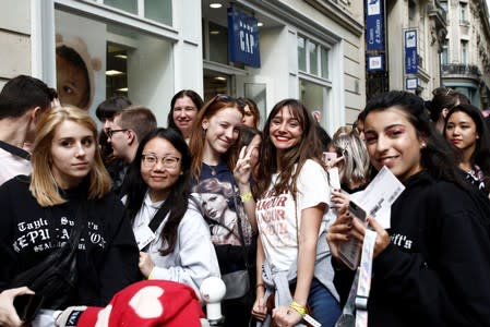 Fans of Taylor Swift wait in line to enter the Olympia Theatre prior to her concert performance in Paris