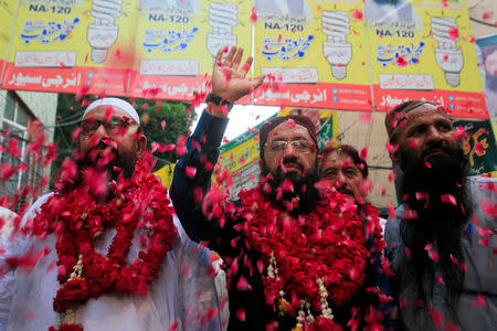 Mohammad Yaqoob Sheikh (C) nominated candidate of political party Milli Muslim League (MML), waves to his supporters during an election campaign for the National Assembly NA-120 constituency in Lahore, Pakistan September 9, 2017. REUTERS/Mohsin Raza