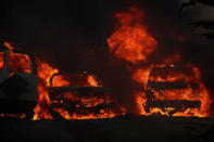 Cars burn along with a home during the Lilac Fire, a fast moving wild fire in Bonsall, California, U.S., December 7, 2017. REUTERS/Mike Blake