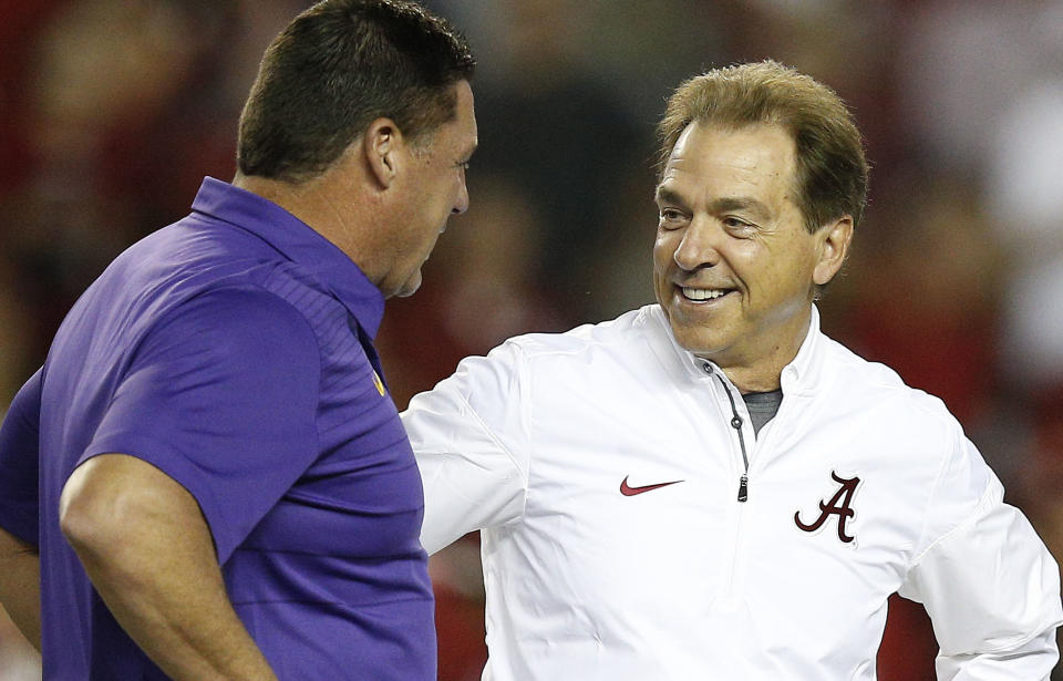 Nick Saban (R) and the Crimson Tide are two-touchdown favorites on the road in Death Valley against Ed Orgeron’s Tigers. (AP)