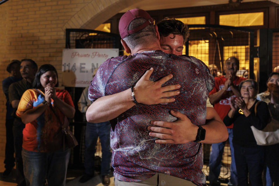 Cody Smith embraces his son Caden Smith as they celebrate his win in the special mayoral election, Tuesday night, Nov. 7, 2023, in Uvalde, Texas. In Uvalde’s first mayoral race since the Robb Elementary School shooting, Smith won back the job Tuesday over Kimberly Mata-Rubio, a mother who has led calls for tougher gun laws since her daughter was among the 19 children killed in the 2022 attack. (Sam Owens/The San Antonio Express-News via AP)