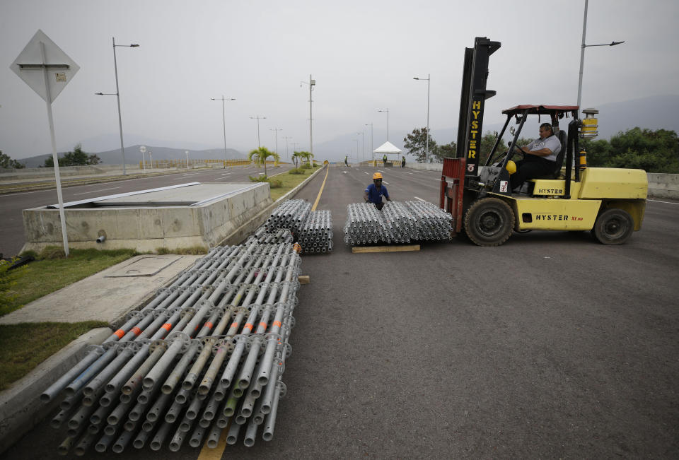 Workers unload material for building the stage of the upcoming “Venezuela Aid Live” concert at the Tienditas International Bridge on the outskirts of Cucuta, Colombia, on the border with Venezuela, Monday, Feb. 18, 2019. Billionaire Richard Branson is organizing the concert on Feb. 22 featuring Spanish-French singer Manu Chao, Mexican band Mana, Spanish singer-songwriter Alejandro Sanz and Dominican artist Juan Luis Guerra. (AP Photo/Fernando Vergara)