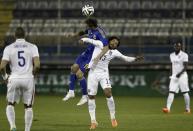 Ukraine's Denys Garmash (top) challenges Jermaine Jones of the U.S. during their international friendly soccer match in Larnaca, March 5, 2014. REUTERS/Yorgos Karahalis (CYPRUS - Tags: SPORT SOCCER)