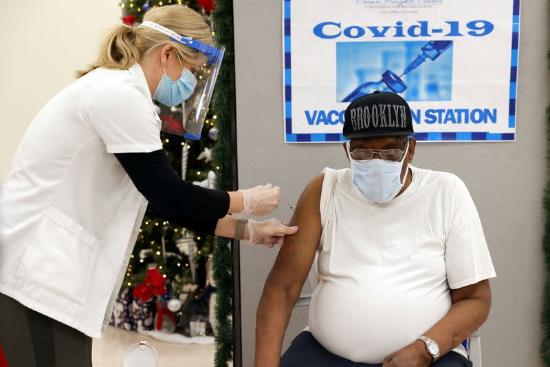 FILE PHOTO: George Valley, a patient at Crown Heights Center for Nursing and Rehabilitation, receives the Pfizer-BioNTech COVID-19 vaccine from Walgreens Pharmacist Annette Marshall in Brooklyn