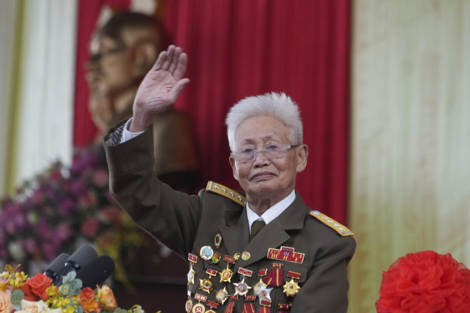Veteran Phạm Duc Cu waves to the gathering during a parade commemorating the victory of Dien Bien Phu battle in Dien Bien Phu, Vietnam, Tuesday, May 7, 2024. Vietnam is celebrating the 70th anniversary of the battle of Dien Bien Phu, where the French army was defeated by Vietnamese troops, ending the French colonial rule in Vietnam. (AP Photo/Hau Dinh)