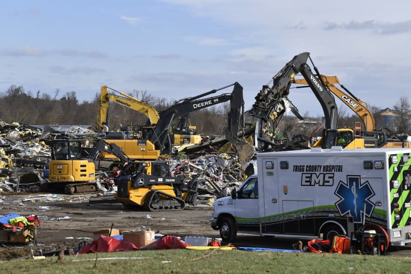 Emergency response workers dig through the rubble of the Mayfield Consumer Products candle factory in Mayfield, Ky., Saturday, Dec. 11, 2021. Tornadoes and severe weather caused catastrophic damage across multiple states late Friday, killing several people overnight. (AP Photo/Timothy D. Easley)