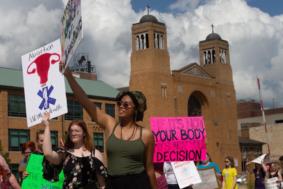 Abortion-rights supporters carried messages as hundreds marched around the Kansas Statehouse on July 30. After the so-called Value Them Both constitutional amendment was defeated Tuesday, some are asking how the measure will impact the November election.