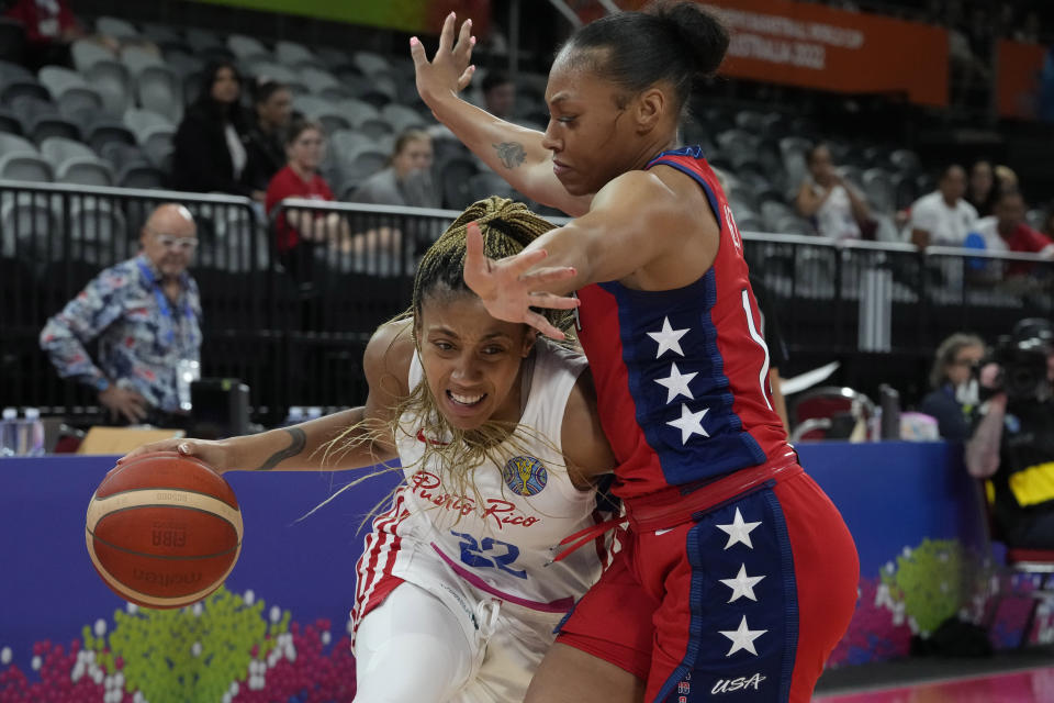 Puerto Rico's Arella Guirantes tries to get the ball past United States' Betnijah Laney at the women's Basketball World Cup in Sydney, Australia, Friday, Sept. 23, 2022. (AP Photo/Mark Baker)
