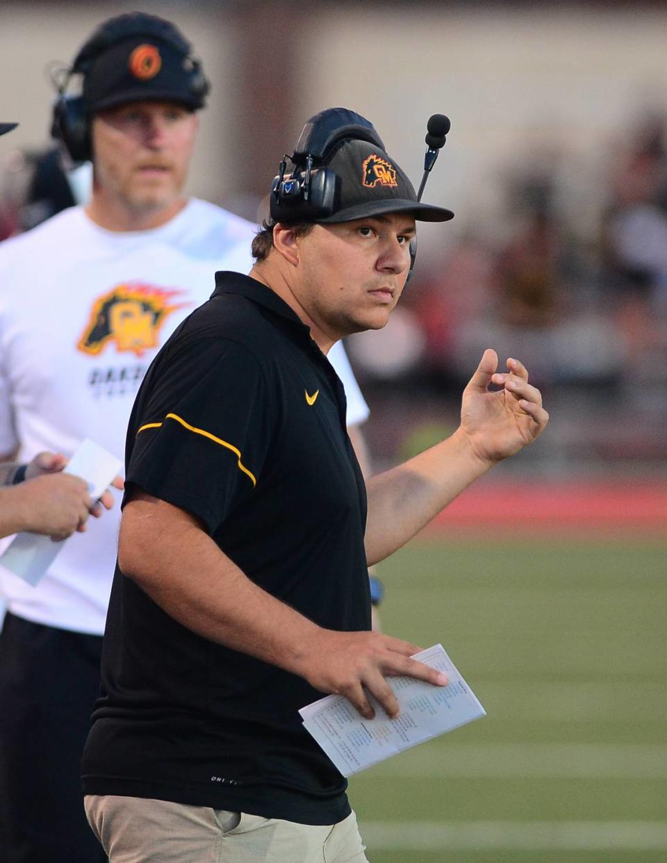 Oakdale Head Coach Garrett Martin looks toward the end zone during a game between Oakdale High School and Sonora High School at Oakdale High School in Oakdale California CA on August 18, 2023.