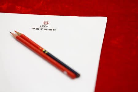 A paper bearing the logo of Industrial and Commercial Bank of China Ltd (ICBC)'s is placed on a desk before its president Yi Huiman's news conference about its annual result announcement at its headquarters in Beijing, China, March 30, 2016. REUTERS/Kim Kyung-Hoon