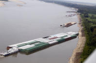 Barges and their towboats accumulate alongside the Mississippi banks of the Mississippi River near Greenville, Miss., Tuesday, Aug. 21, 2012. Officials with the U.S. Army Corps of Engineers say low water levels that are restricting shipping traffic, forcing harbor closures and causing towboats and barges to run aground on the Mississippi River are expected to continue into October. (AP Photo/Rogelio V. Solis)