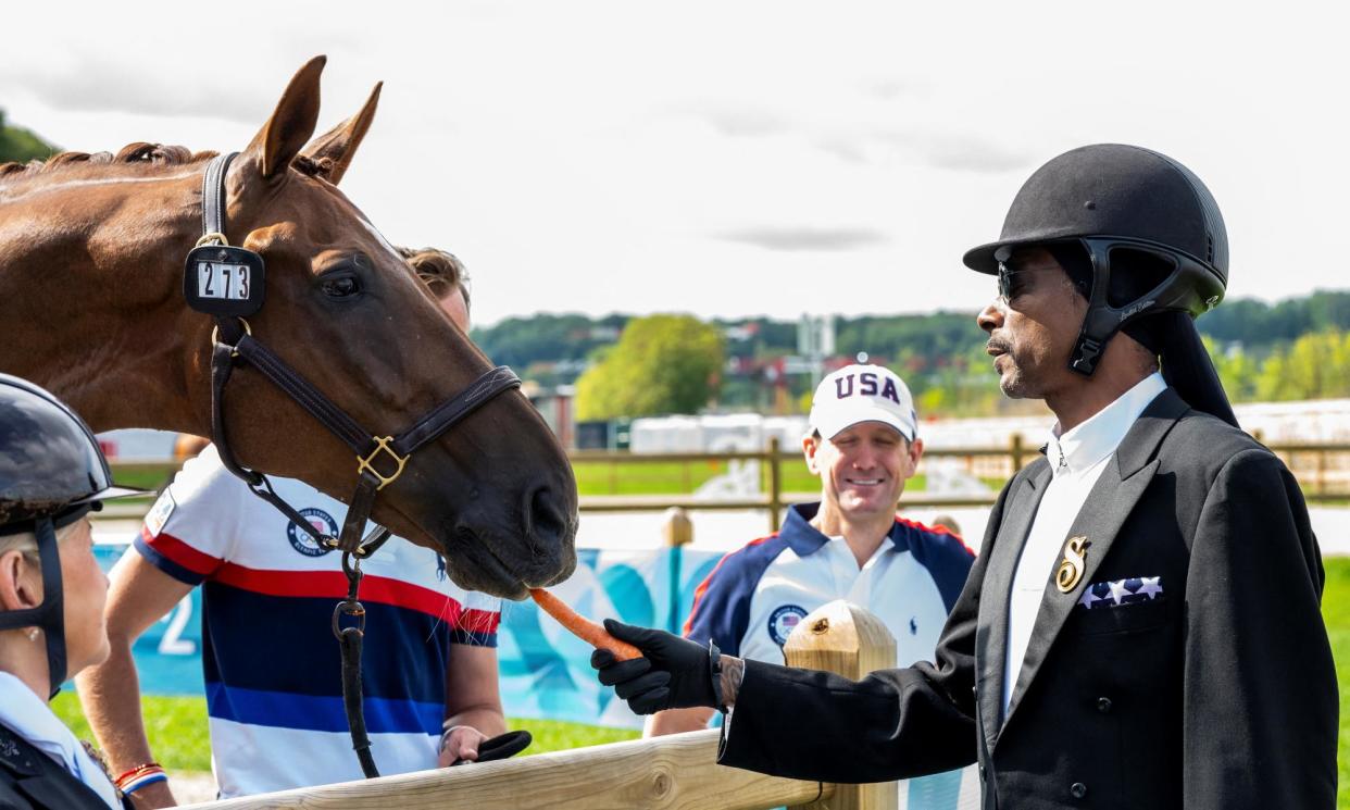 <span>Snoop Dogg – torchbearer, TV correspondent and general hype man – has proved good value at the games.</span><span>Photograph: Lukasz Kowalski/Reuters</span>