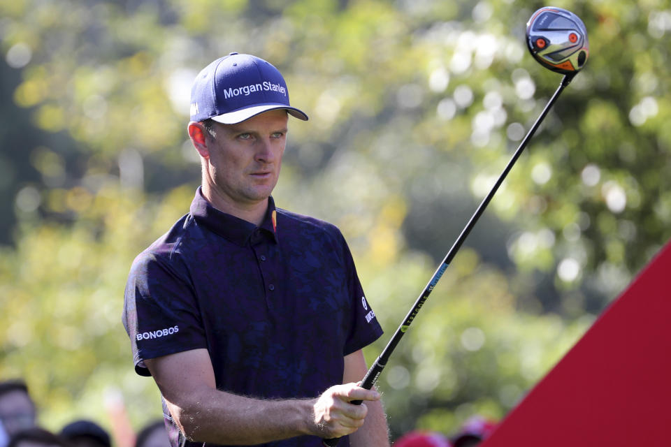 Justin Rose of England lines up his shot for the HSBC Champions golf tournament held at the Sheshan International Golf Club in Shanghai on Friday, Nov. 1, 2019. (AP Photo/Ng Han Guan)