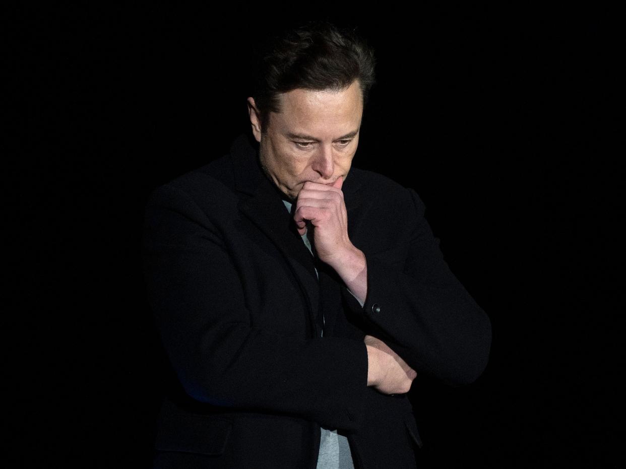 Elon Musk pauses and looks down as he speaks during a press conference at SpaceX's Starbase facility near Boca Chica Village in South Texas on February 10, 2022