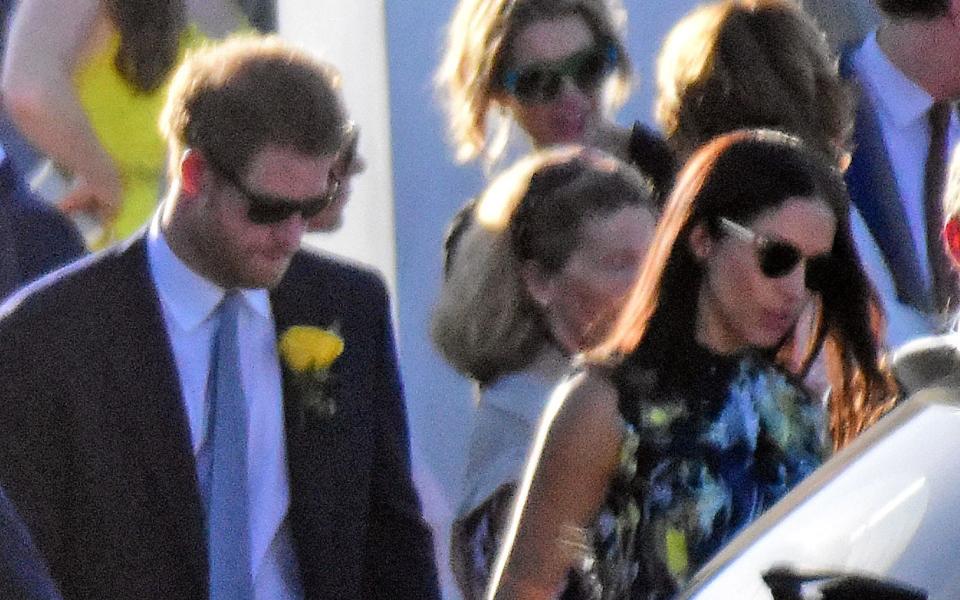 Prince Harry and Meghan Markle put on an affectionate display as they attend wedding in Jamaica