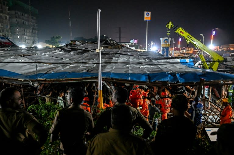 National Disaster Response Force (NDRF) personnel look for survivors during a rescue operation at the site where an advertisement hoarding collapsed on a fuel station after a dust storm in Mumbai on May 13, 2024 (Punit PARANJPE)