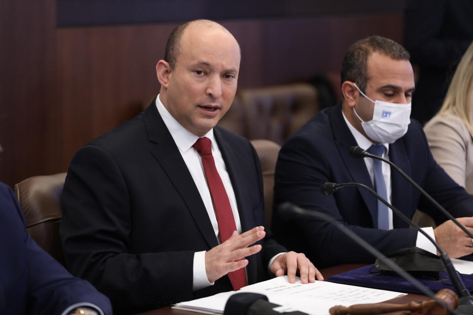 Israeli Prime Minister Naftali Bennett, center, attends a cabinet meeting at the prime minister's office in Jerusalem, Israel, Sunday, Dec. 19, 2021. (Abir Sultan/Pool Photo via AP)