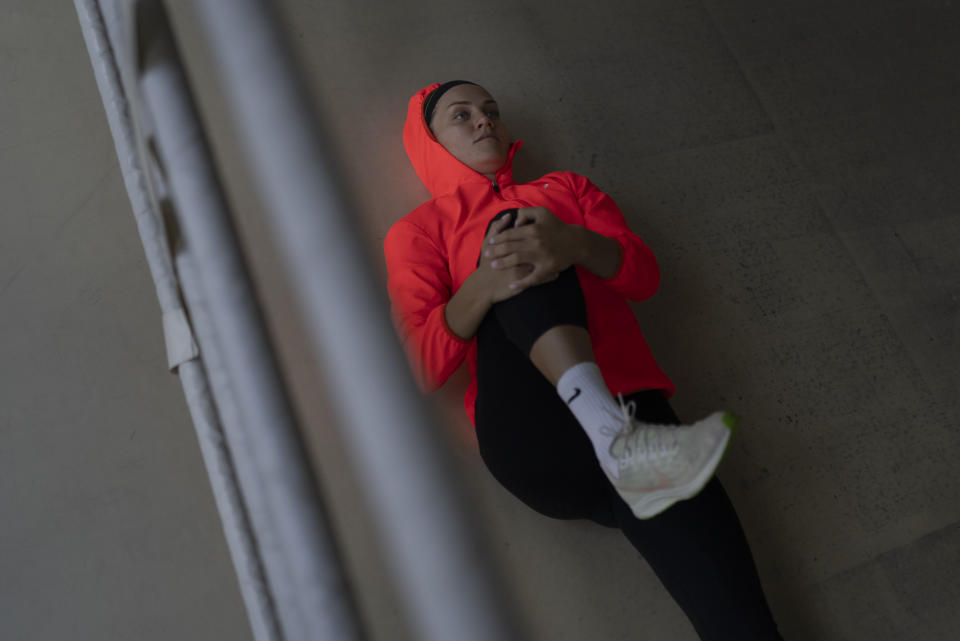 Ukrainian boxer Anna Lysenko stretches in the ring after her training at Kiko Boxing Club in Kyiv, Ukraine, Tuesday, July 11, 2023. The 31-year-old Lysenko refuses to give up on her training. She has already sacrificed almost 10 years of her life for the sport, reaching the quarterfinals in Tokyo but missing out on an Olympic medal after losing to the eventual gold medalist. Knowing the upcoming Paris Games may be her last, she perseveres, training six days a week hoping to get better, to get faster, to win. (AP Photo/Jae C. Hong)