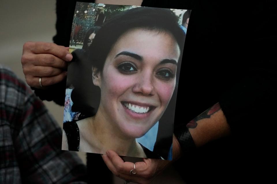 A family picture of Alexandra "Allie" Kurtz, the 26-year-old crew member, galley cook and victim of the Sept. 2, 2019 fire aboard the dive boat, Conception, at Santa Cruz Island, is held by a family member arriving at federal court in Los Angeles on Wednesday, Oct. 25, 2023. Federal prosecutors are seeking justice for 34 people killed in a fire aboard a scuba dive boat called the Conception in 2019. The trial against Capt. Jerry Boylan began Tuesday with jury selection.