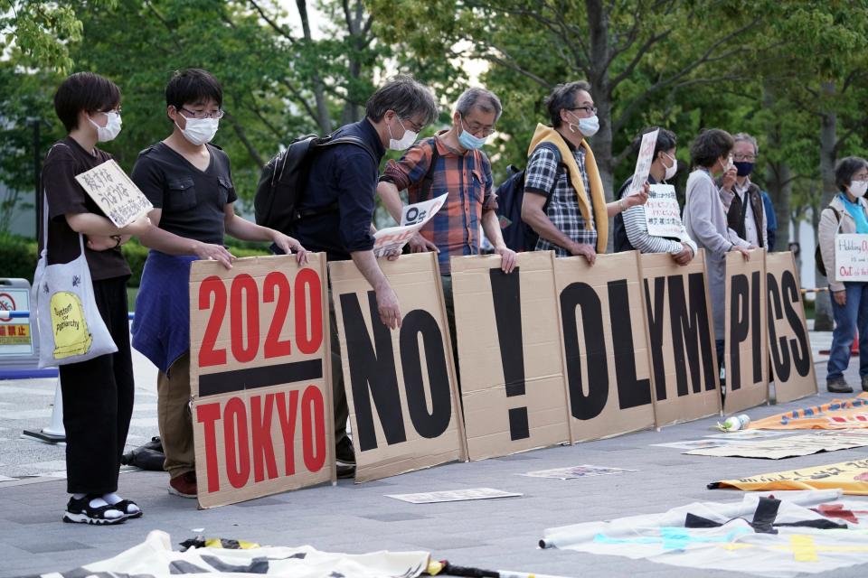 People protest around Tokyo's National Stadium on Sunday, May 9.