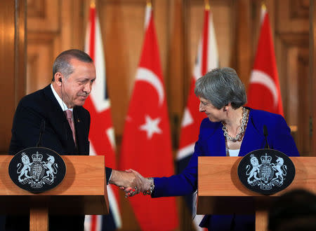 Turkish President Tayyip Erdogan shakes hands with Britain's Prime Minister Theresa May during a news conference after their meeting at Downing Street in London, Britain May 15, 2018. Cem Oksuz/Presidential Palace/Handout via REUTERS 