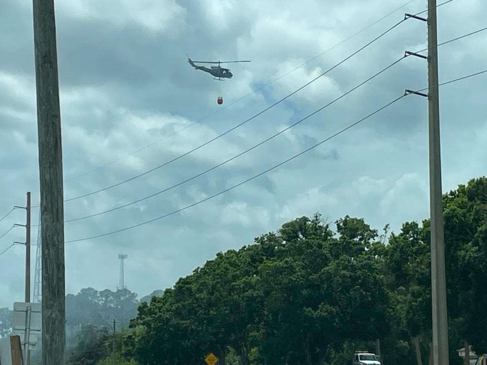 A helicopter from the Florida Forest Service flew over the Palm Bay brush fire Sunday.