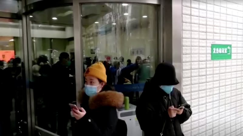 People wearing masks are seen at a hospital in Wuhan