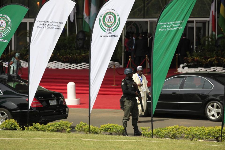 A Nigerian police officer stand guards outside the venue for the summit on security during an event marking the centenary of the unification of Nigeria's north and south in Abuja, Nigeria, Thursday, Feb. 27, 2014, . (AP Photo/Sunday Alamba)