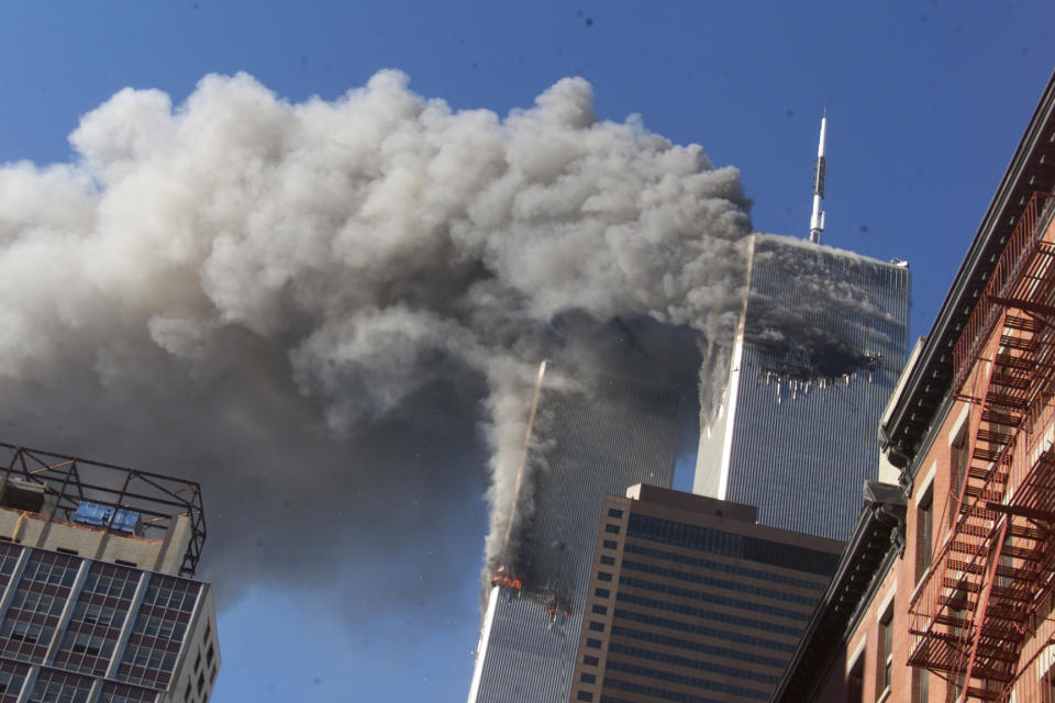<p>Smoke rises from the burning twin towers of the World Trade Center after hijacked planes crashed into the towers. (Reuters)</p> 