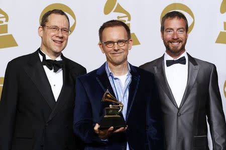 Singers Glenn Miller (L) and Robert Harlan (R) pose with Conductor Craig Hella Johnson and his award for best choral performance for his work on "The Sacred Spirit Of Russia" backstage at the 57th annual Grammy Awards in Los Angeles, California February 8, 2015. REUTERS/Mike Blake