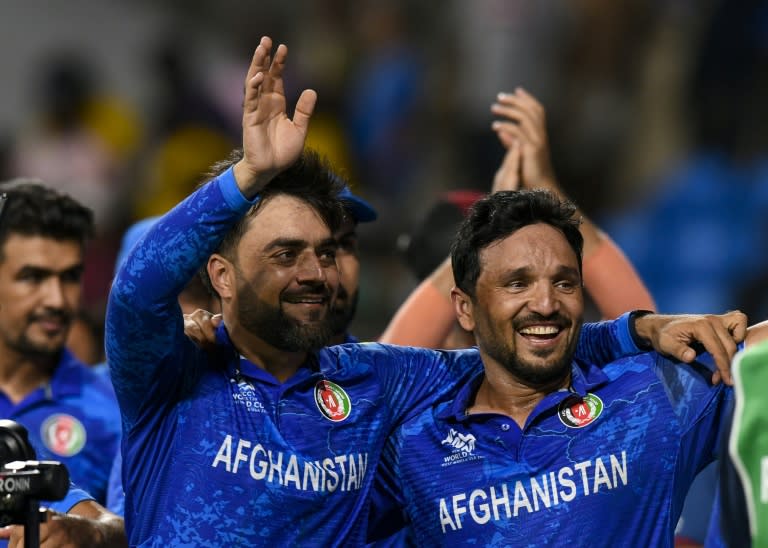 Global cricket star: Afghanistan captain Rashid Khan (L) and Gulbadin Naib celebrate their win over Bangladesh which took them to the T20 World Cup semi-finals (Randy Brooks)
