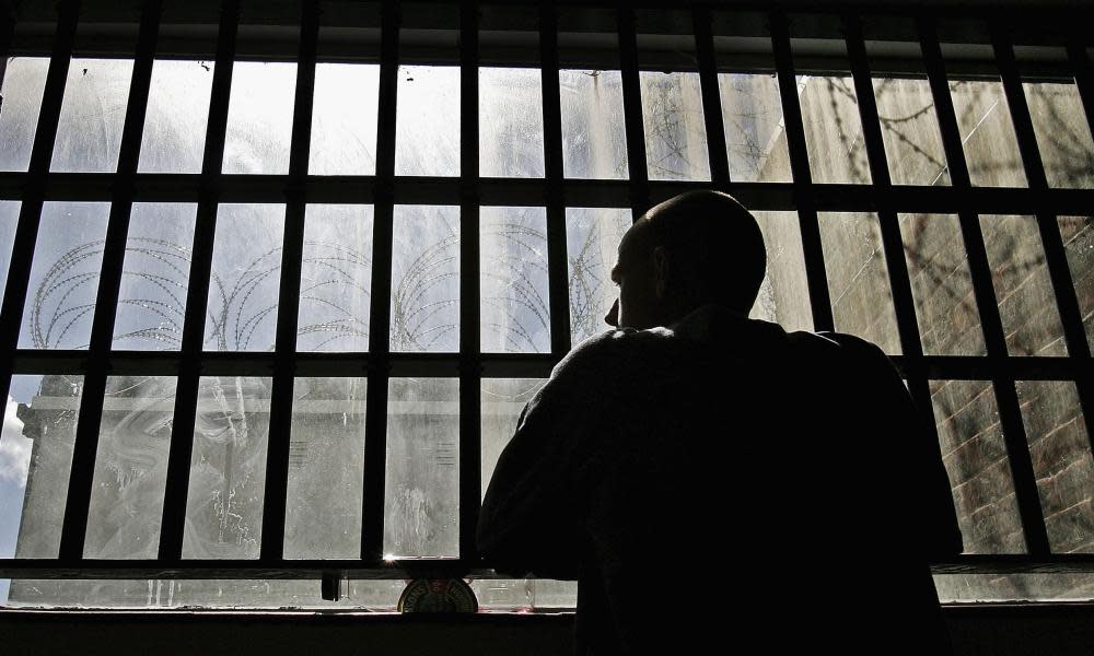 Prisoner looking through bars