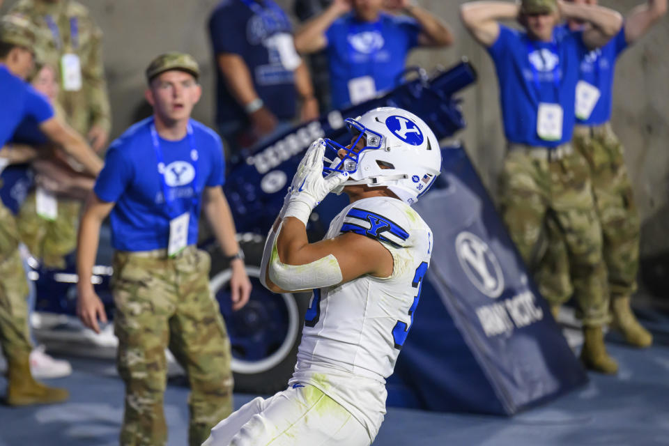 Brigham Young running back Sione I Moa (30) blows a kiss to the crowd after scoring a touchdown during an NCAA football game against Kansas St., on Saturday, Sept. 21, 2024 in Provo, Utah. (AP Photo/Tyler Tate)